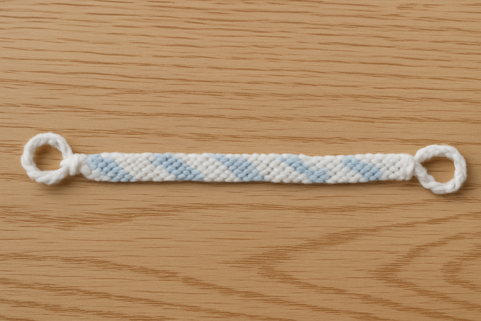 Professional wool lanyard on wood surface